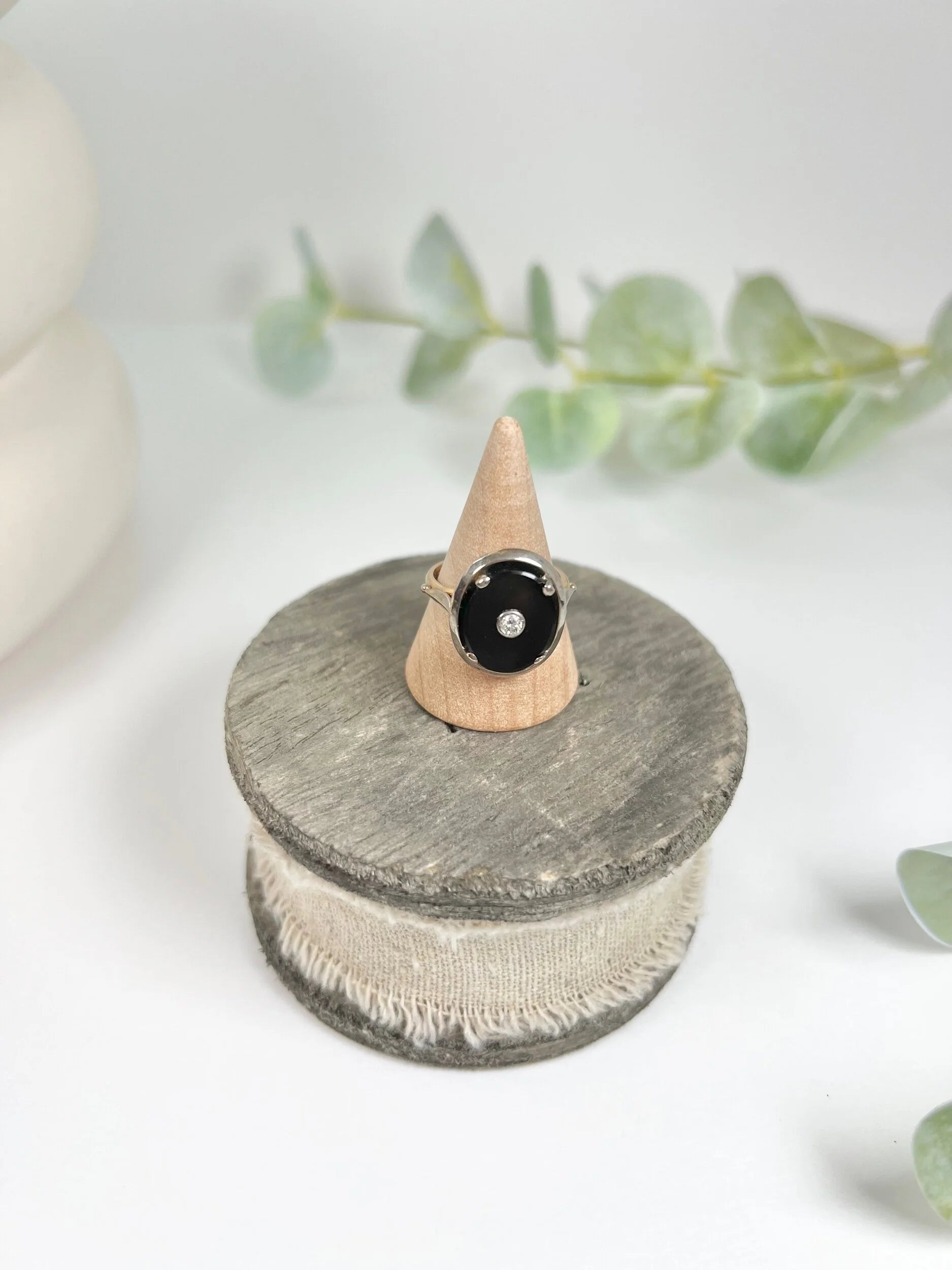Art Deco 18 Carat Two Colour Gold Oval Onyx and Diamond Halo Ring, Circa 1920