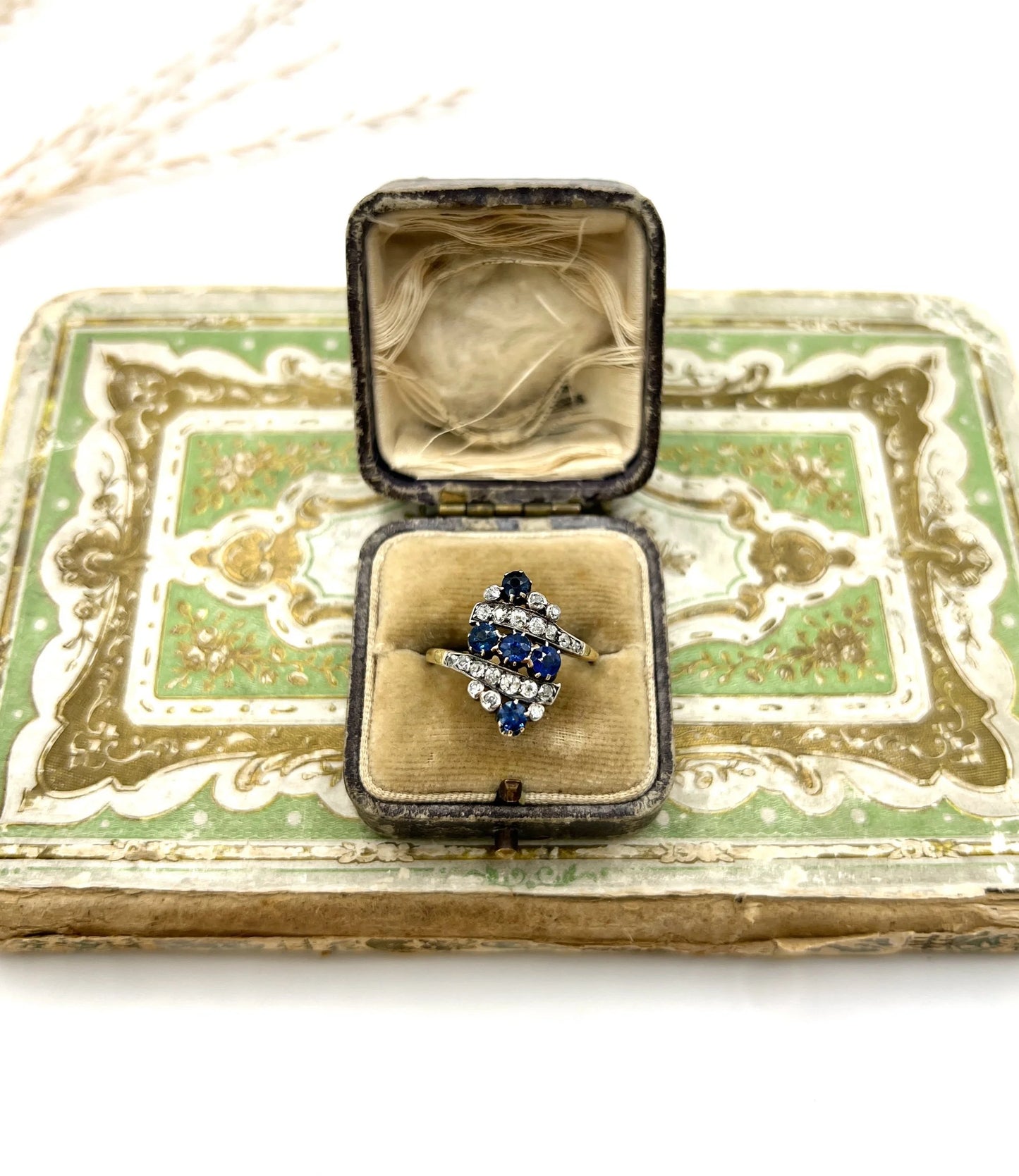 A navette shaped sapphire and diamond ring in yellow gold, in an antique ring box