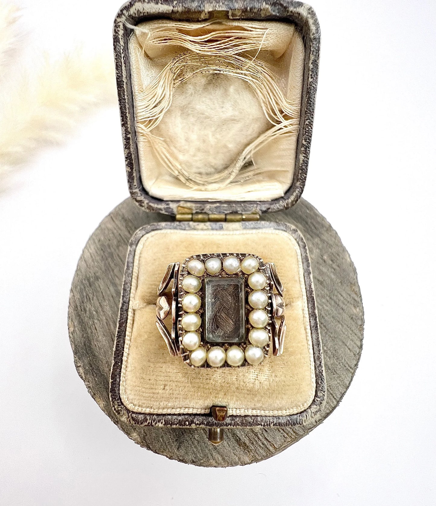 An antique seed pearl mourning ring in gold, in a ring box