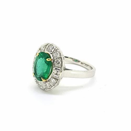 Emerald and Diamond Oval Cluster Ring; featuring a central 2.29 carat oval faceted emerald surrounded by 0.90cts asscher and brilliant-cut diamonds, in 18ct gold