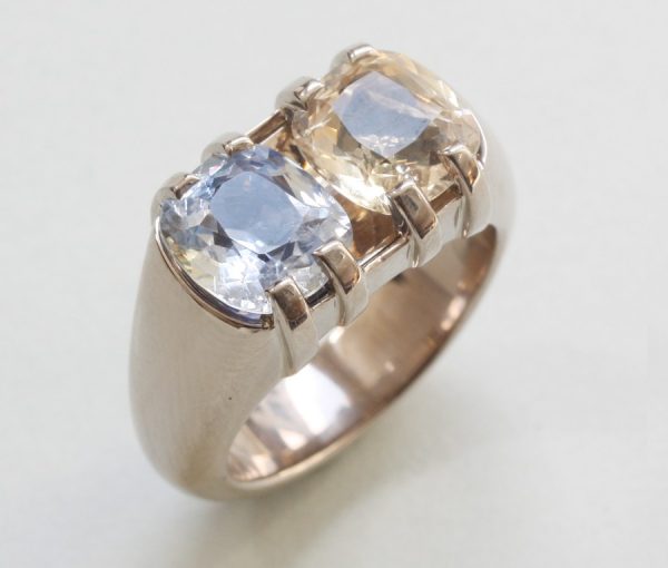 Blue and Yellow Cushion Cut Sapphire and 18ct Grey Gold Heavy Dress Ring; set with a 2.80ct light blue sapphire and 2.73ct yellow sapphire