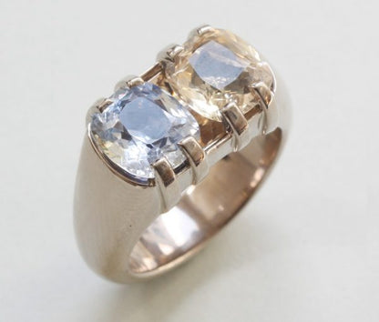 Blue and Yellow Cushion Cut Sapphire and 18ct Grey Gold Heavy Dress Ring; set with a 2.80ct light blue sapphire and 2.73ct yellow sapphire