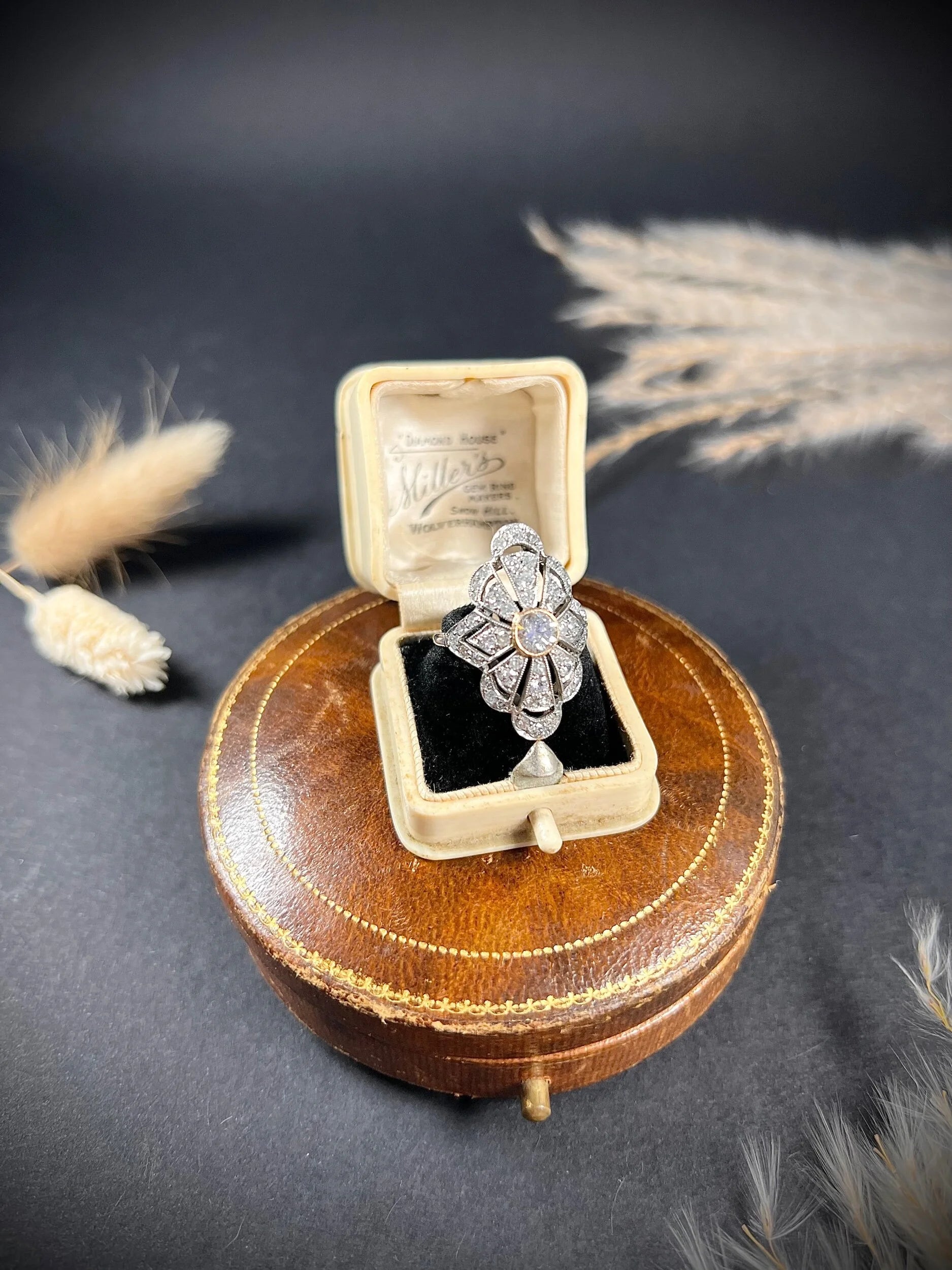 A diamond cocktail ring in white metal, in an antique ring box