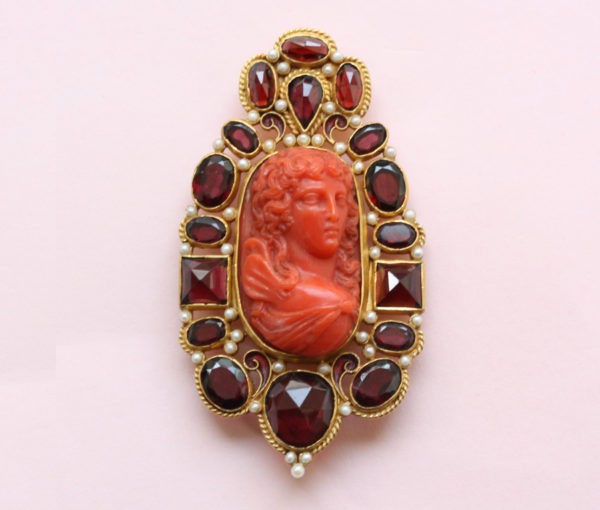 Neo Renaissance Style Pearl and Garnet set Cameo Brooch; 19thC cameo surrounded by later small pearls and garnets, 18ct gold, Circa 1980.