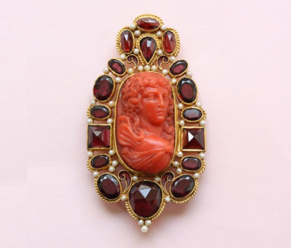 Neo Renaissance Style Pearl and Garnet set Cameo Brooch; 19thC cameo surrounded by later small pearls and garnets, 18ct gold, Circa 1980.
