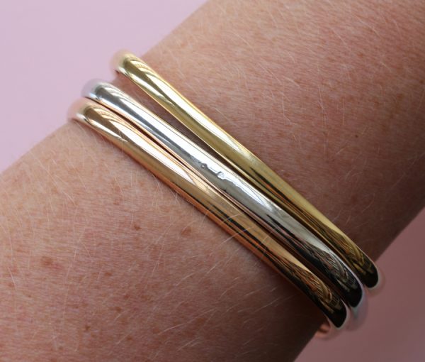 Vintage Tri Colour 18ct Gold Bangle; three heavy 18ct gold rounded square bangles; one yellow, one rose and one white gold, France, 1970's