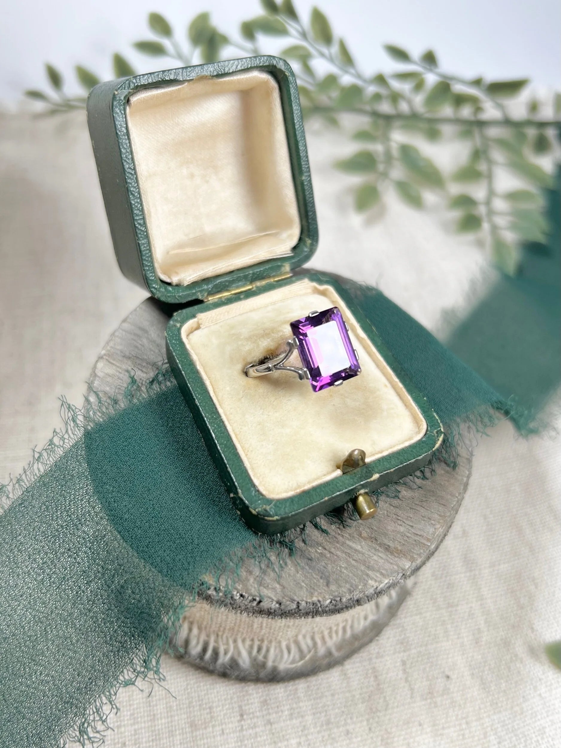 A solitaire amethyst cocktail ring in platinum, in a ring box