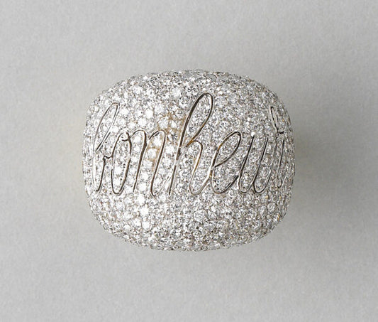 Diamond Bonheur Bombe Dress Ring; set with 4cts brilliant cut diamonds in which is graceful cursive lettering the word Bonheur, echoed inside the band in 18ct yellow gold