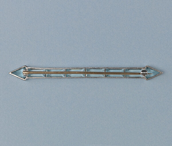 Art Deco Aquamarine Arrow Bar Brooch; baguette-cut and diamond-shaped aquamarines mounted in platinum, arrow design, on a yellow gold pin.