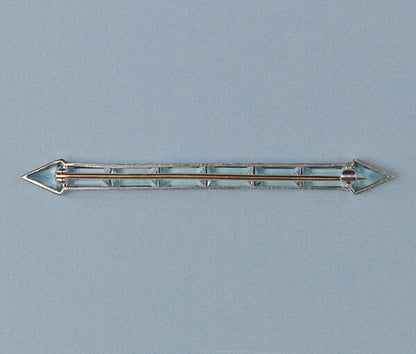 Art Deco Aquamarine Arrow Bar Brooch; baguette-cut and diamond-shaped aquamarines mounted in platinum, arrow design, on a yellow gold pin.