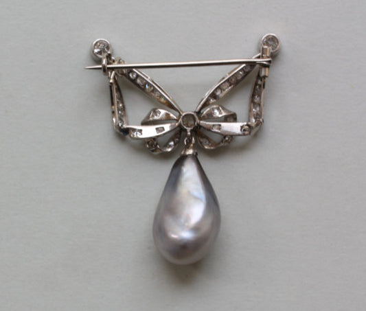 Antique Edwardian Old Cut Diamond, Natural Pearl and Platinum Bow Brooch; set with 39 single and old-cut diamonds, 12ct natural grey pearl drop, with certificate