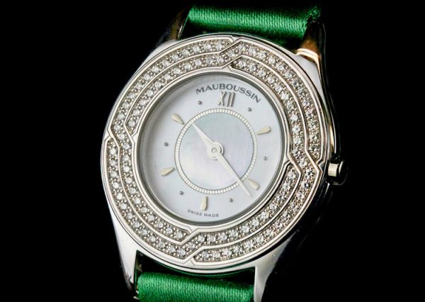 Mauboussin Ladies 18ct Gold and Diamond 26mm Quartz Watch, 18ct gold case, 1.00ct diamond bezel, on a green Mauboussin fabric strap.
