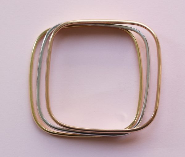 Vintage Tri Colour 18ct Gold Bangle; three heavy 18ct gold rounded square bangles; one yellow, one rose and one white gold, France, 1970's