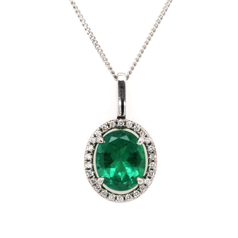 Emerald and diamond cluster pendant in white gold.