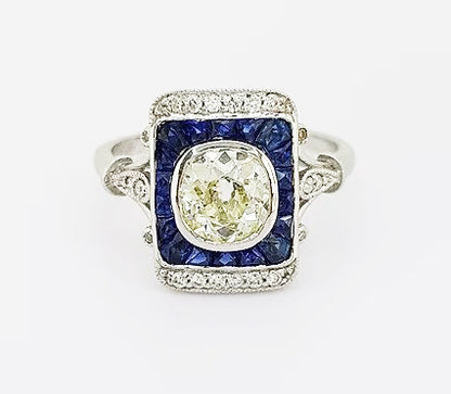 Vintage 1.25ct Old Cut Diamond and Sapphire Panel Ring; 1.25ct old-cut diamond, surrounded by calibre-cut sapphires and brilliant-cut diamonds, 18ct gold