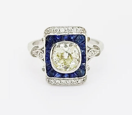 Vintage 1.25ct Old Cut Diamond and Sapphire Panel Ring; 1.25ct old-cut diamond, surrounded by calibre-cut sapphires and brilliant-cut diamonds, 18ct gold