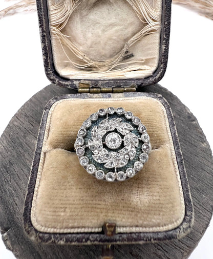 A diamond and dark blue enamel fancy cluster ring in white gold, in an antique ring box