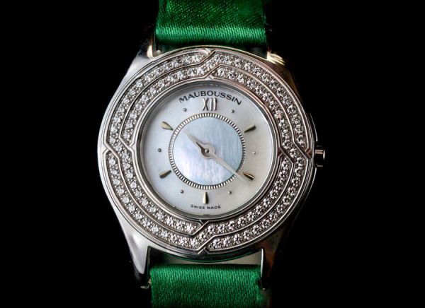 Mauboussin Ladies 18ct Gold and Diamond 26mm Quartz Watch, 18ct gold case, 1.00ct diamond bezel, on a green Mauboussin fabric strap.