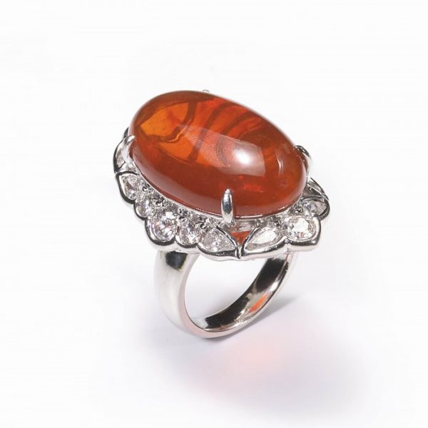 Cabochon Fire Opal and Diamond Cluster Ring in Platinum; central 18.00 carat oval shaped cabochon-cut fire opal, surrounded by 2.40cts brilliant and pear-cut diamonds