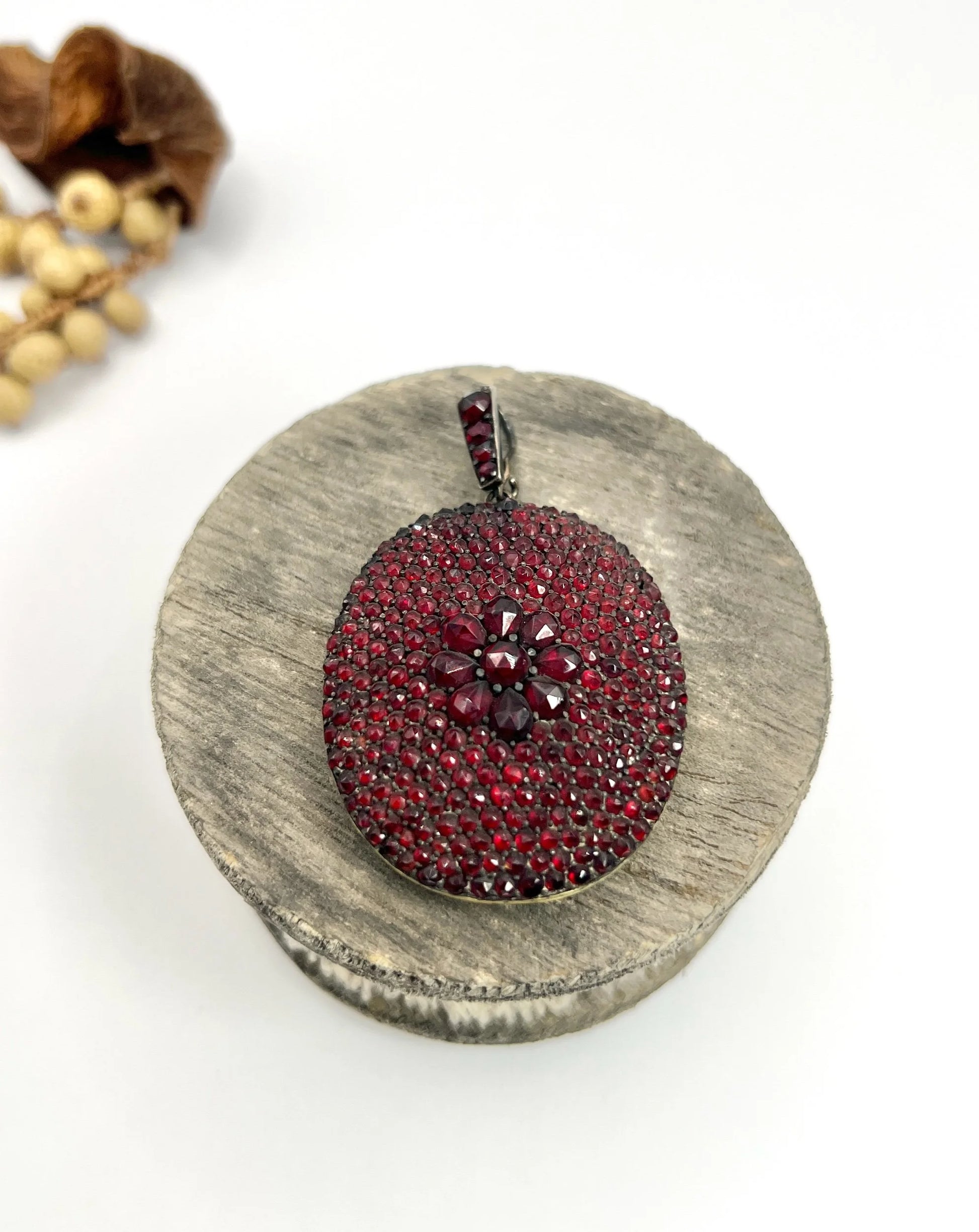 An antique oval locket encrusted with garnets