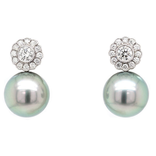 Tahitian Pearl and Diamond Drop Earrings A beautiful pair of 13.9mm Tahitian pearl earrings sitting below a diamond flower design cluster stud
