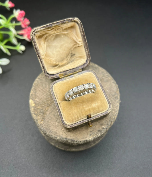 A white metal diamond full eternity band ring, in an antique ring box
