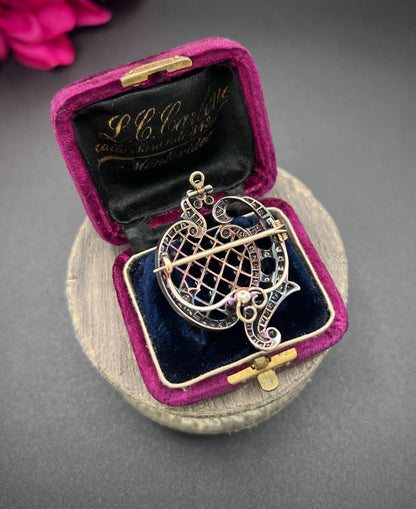 An openwork diamond set antique brooch in yellow gold and silver, in an antique box