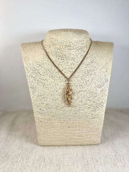 A yellow gold floral crescent pendant with pearls, with a chain