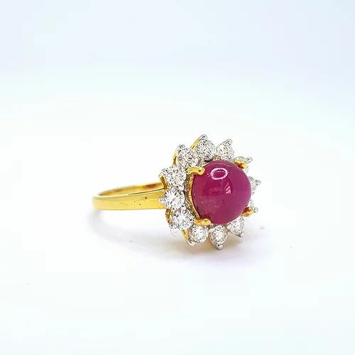 Cabochon Burma Ruby and Diamond Cluster Ring; central round cabochon Burmese ruby surrounded by sparkling diamonds, in 18ct yellow gold