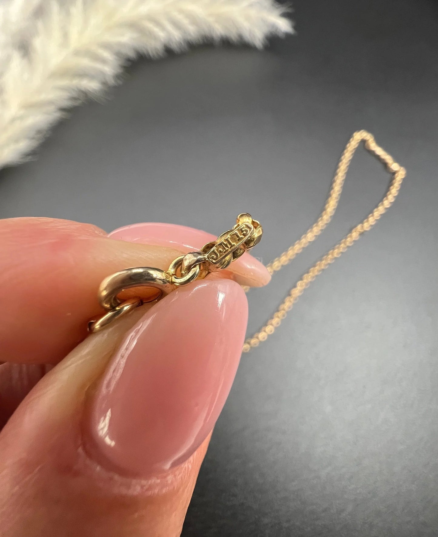 A gold belcher link necklace, showing stamps close-up