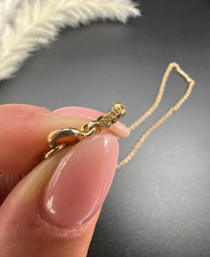 A gold belcher link necklace, showing stamps close-up