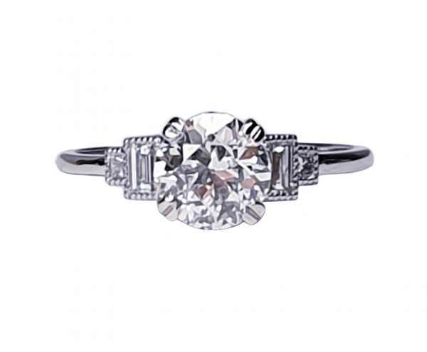 Vintage 1.06ct Old Cut Diamond and Platinum Engagement Ring; featuring a 1.06 carat G colour VS1 clarity old European transitional cut diamond with baguette and radiant-cut diamond shoulders, in platinum
