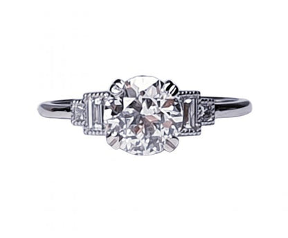 Vintage 1.06ct Old Cut Diamond and Platinum Engagement Ring; featuring a 1.06 carat G colour VS1 clarity old European transitional cut diamond with baguette and radiant-cut diamond shoulders, in platinum