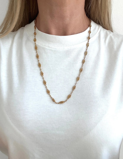 A yellow gold fancy link chain necklace, modelled