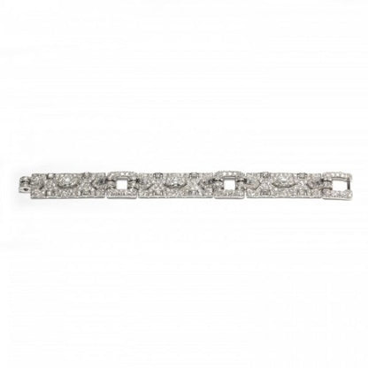 Vintage Cartier Diamond Bracelet; comprised of three panels, each set with a central trap-cut diamond flanked by triangular and fancy-cut diamonds, accented with transitional brilliant-cut and single-cut diamond set surrounds, 18.70 carat total. Mounted in platinum. Circa 1930