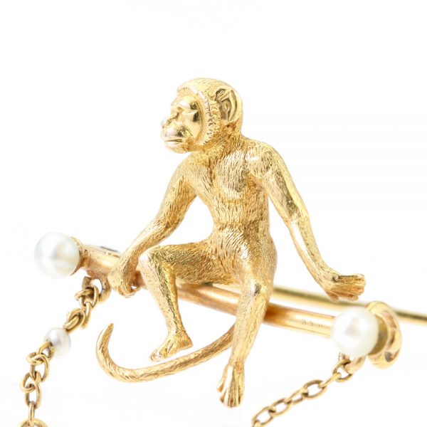 Art Deco 18ct Yellow Gold Monkey Brooch with Pearls; novelty "Monkey Around" brooch crafted from 18ct yellow gold with textured detailing and accented with two pearls. Made in France, Circa 1920