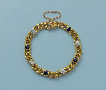 Antique French 18ct Yellow Gold Curb Link Bracelet with Diamonds and Sapphires; with 4 old-cut diamonds totalling 2.50cts and 4 round facetted blue sapphires totalling 3.92cts, Circa 1910