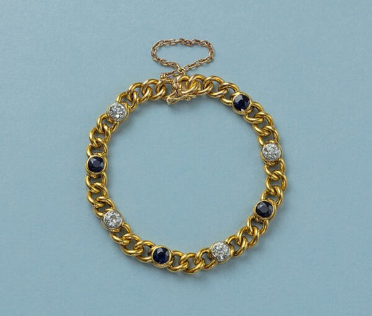 Antique French 18ct Yellow Gold Curb Link Bracelet with Diamonds and Sapphires; with 4 old-cut diamonds totalling 2.50cts and 4 round facetted blue sapphires totalling 3.92cts, Circa 1910
