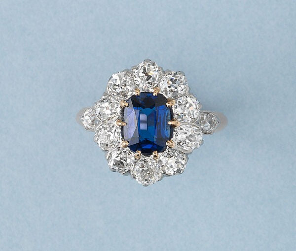 Antique Victorian Sapphire and Old Cut Diamond Cluster Ring; central 1.77ct oval cut untreated gorgeous vibrant blue sapphire surrounded by ten old cut diamonds totalling 2 carats, with diamond set shoulders in bullet shaped bezels, in 18ct rose gold. Made in France, late 19th century, Circa 1890