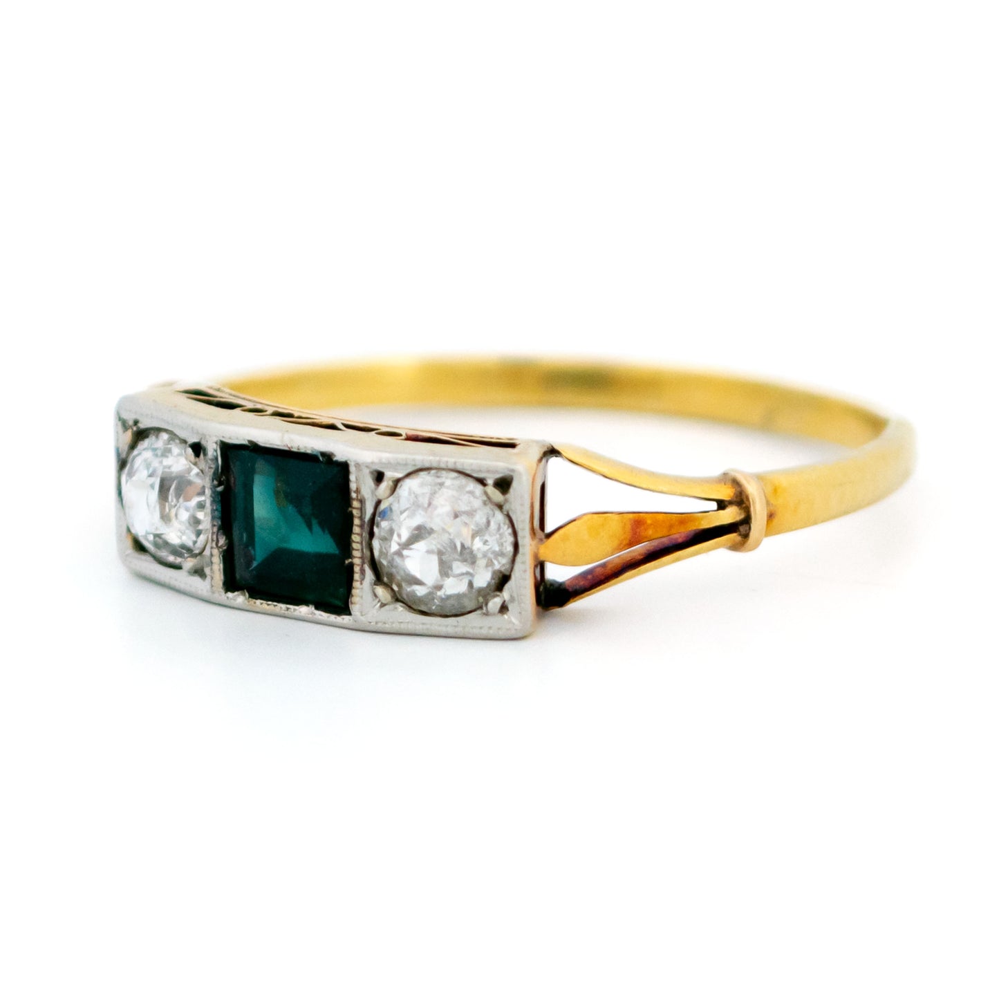 A three stone sapphire and diamond ring in yellow and white gold