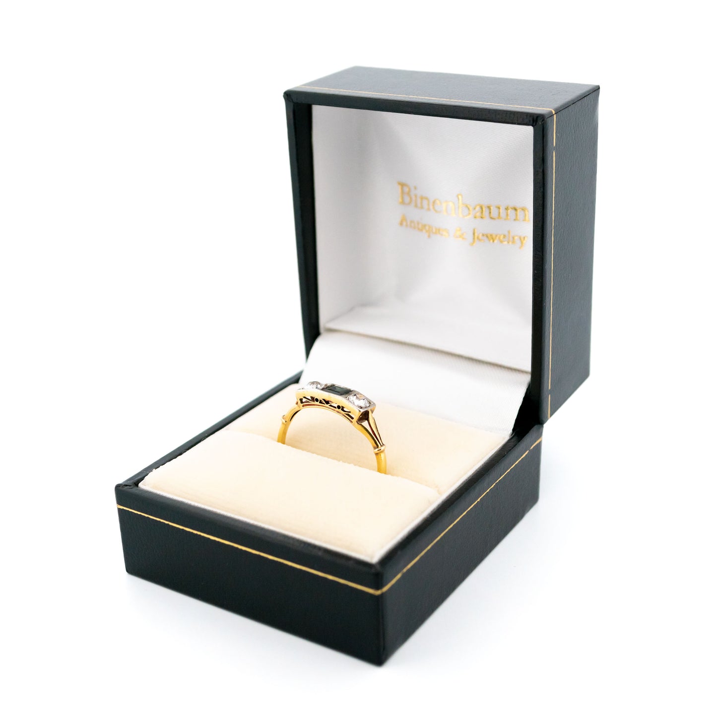 A three stone sapphire and diamond ring in yellow and white gold, in a ring box