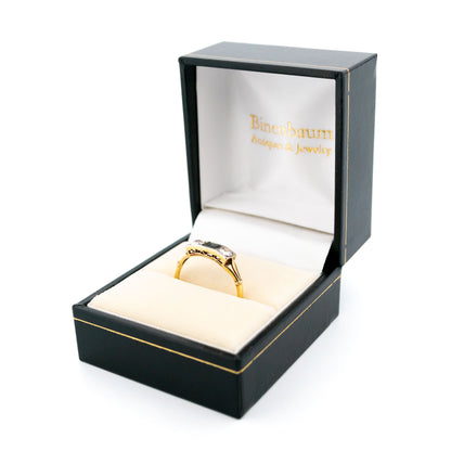 A three stone sapphire and diamond ring in yellow and white gold, in a ring box