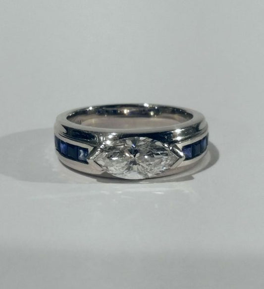Vintage Marquise Diamond and Sapphire Band Ring; set with a 1.25ct marquise cut diamond with square cut sapphire shoulders, in platinum, Circa 1980s