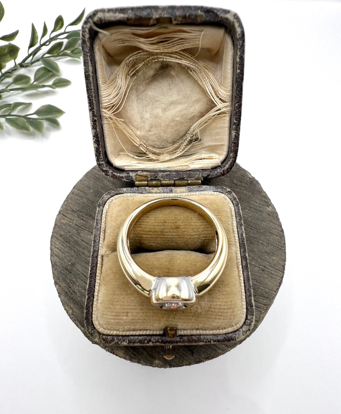 A single stone brilliant cut diamond ring bezel set in yellow gold, in a ring box