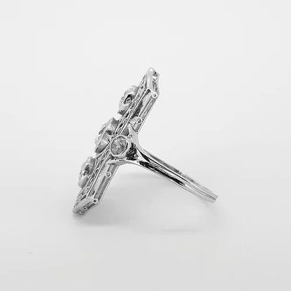 Belle Epoque Three Stone Diamond Plaque Ring; three central diamonds within an openwork platinum mount, diamond set shoulders, 1.50 carats