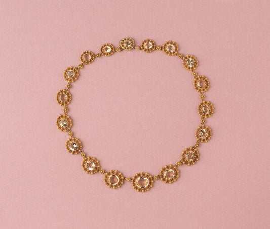 Antique Gold and Topaz Cluster Necklace; set with eighteen graduating oval topaz, each richly decorated with 18ct yellow gold cannetille and granulation, France, Circa 1840