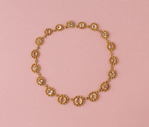 Antique Gold and Topaz Cluster Necklace; set with eighteen graduating oval topaz, each richly decorated with 18ct yellow gold cannetille and granulation, France, Circa 1840