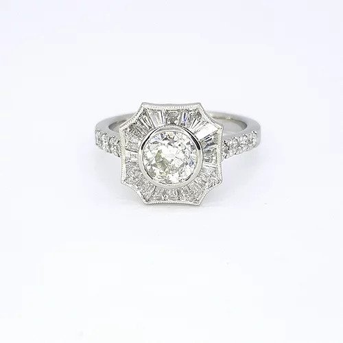 Old Cut Diamond Cluster Target Ring; central 0.69 carat old cut diamond surrounded by calibre cut diamonds, diamond set shoulders, in 18ct white gold