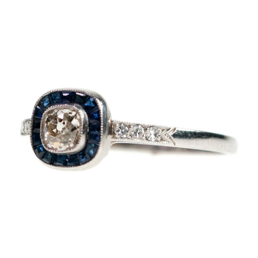 A halo cluster ring with sapphires and diamonds in platinum