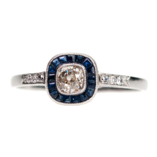 A halo cluster ring with sapphires and diamonds in platinum